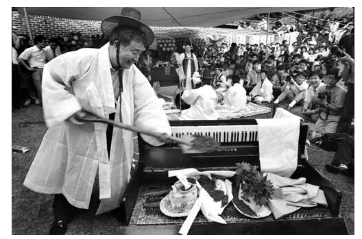 1990년 7월 백남준이 정신적 동지였던 독일 예술가 요셉 보이스(1921~1986)의 추모굿 ‘늑대걸음으로’ 현장에서 속이 빈 피아노에 삽으로 흙을 뿌리고 있다.